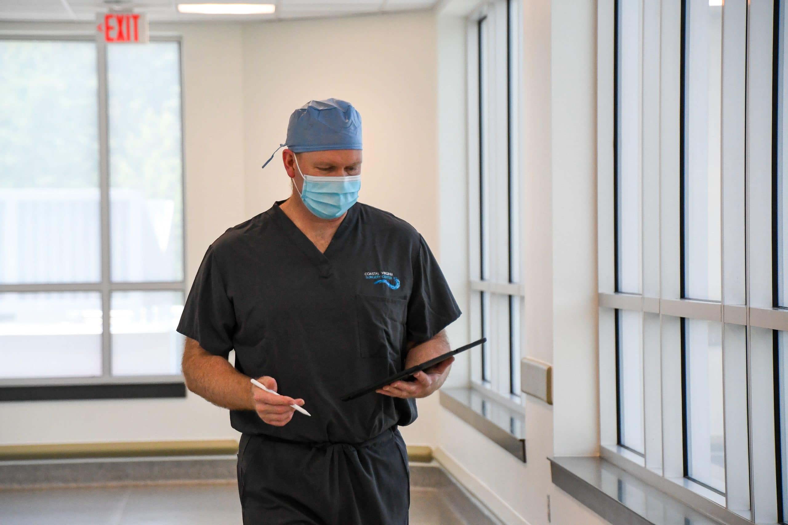 Dr. Jeffrey Carlson checks a patient’s chart between surgeries.